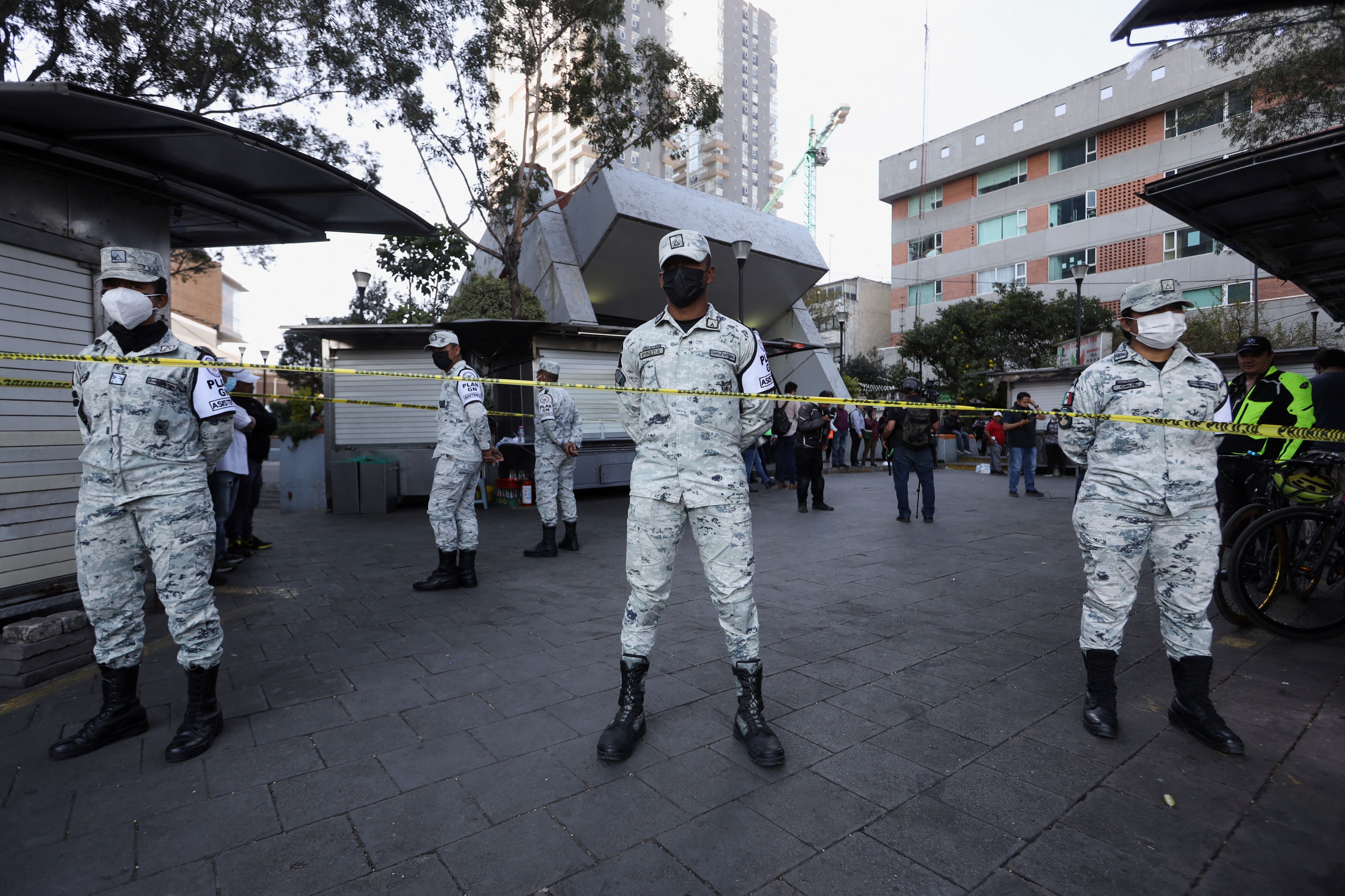 Members of the national guard stand guard after a fire caused by a short circuit at the Barranca del Muerto metro station in Mexico City.