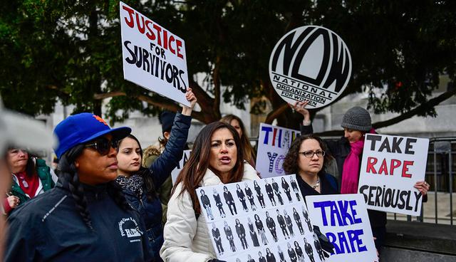 Sonia Ossorio, center, president of the National Organization for Women of New York, leads a group in protest, after Bill Cosby arrives for his sexual assault trial at the Montgomery County Courthouse, Monday, April 9, 2018, in Norristown, Pa. (AP Photo/Corey Perrine)