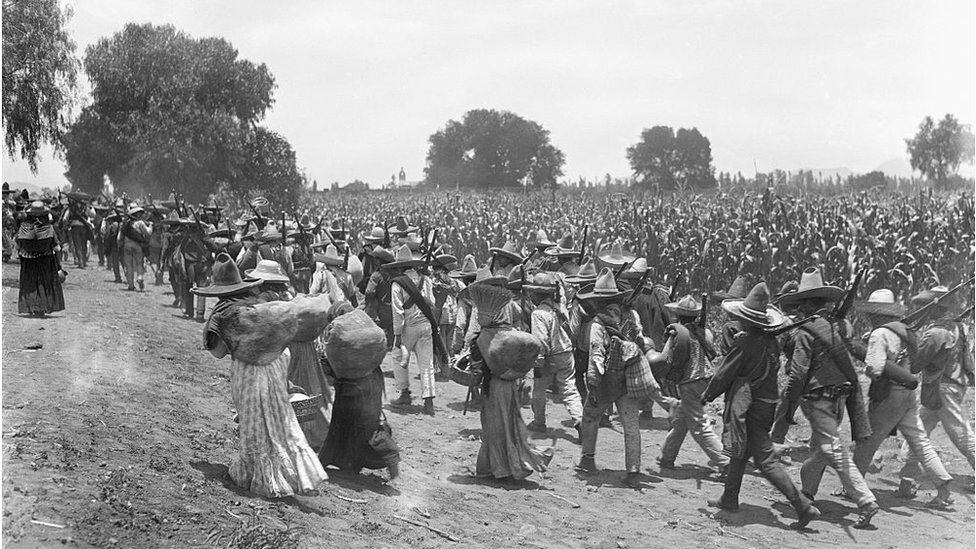 Men and women march during the Mexican revolution.  (GETTY IMAGES)