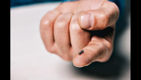 cropped view of man holding  microchip on finger