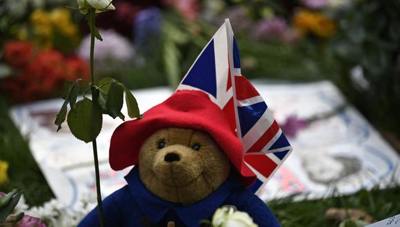 Un oso de peluche Paddington Bear se representa con tributos florales en Green Park, cerca del Palacio de Buckingham, en Londres el 11 de septiembre de 2022. (Foto de STEPHANE DE SAKUTIN / AFP)