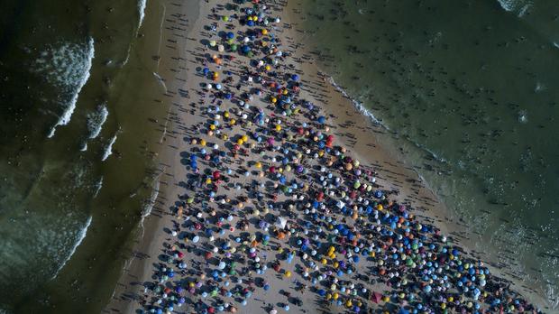 Aerial view of people enjoying Recreio dos Bandeirantes beach amid hot weather in Rio de Janeiro, Brazil, taken on March 17, 2024.  (Photo: TERCIO TEIXEIRA / AFP).
