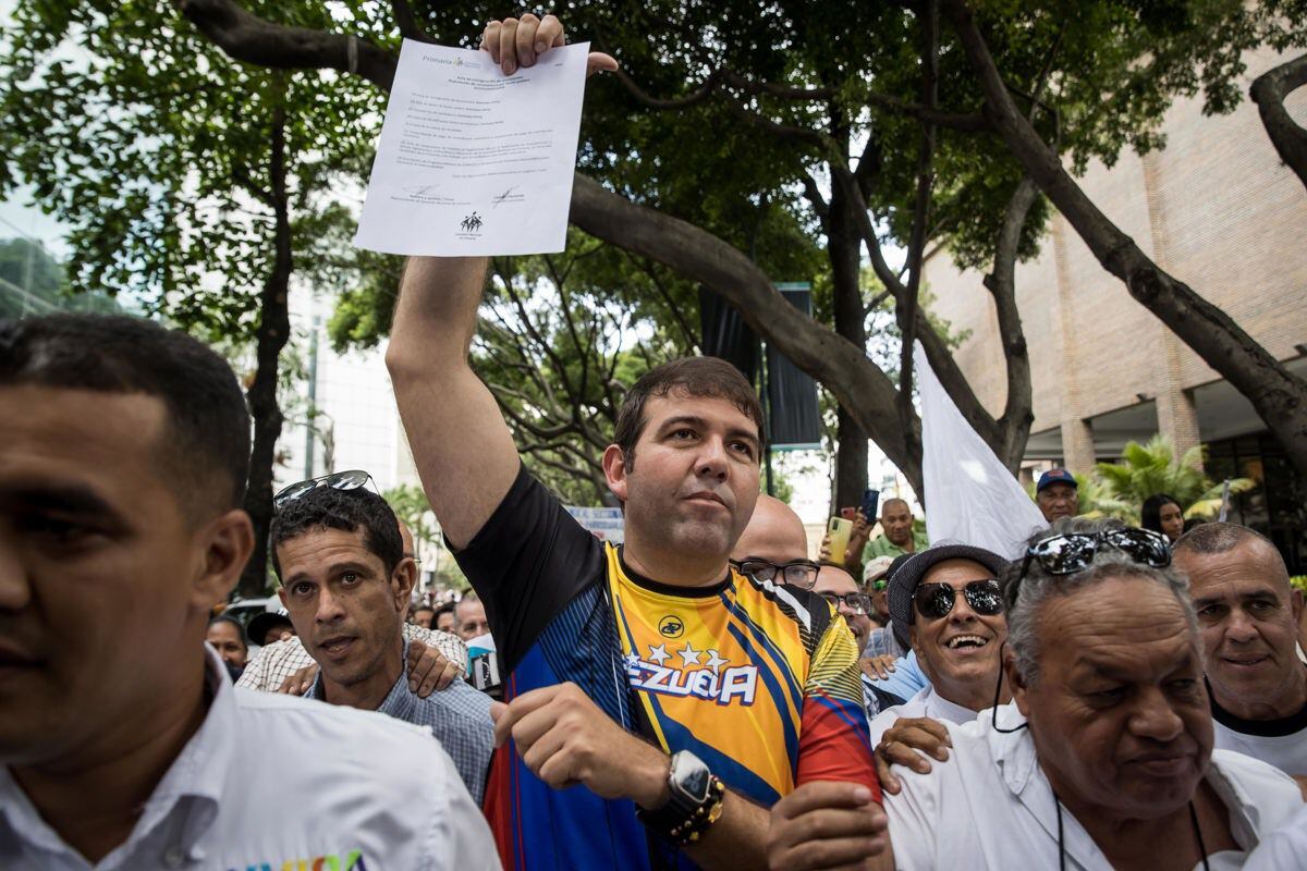 Carlos Prósperi with supporters upon arrival to register as a candidate for the internal elections before the National Commission of Primaries (CNP), on June 23, 2023, in Caracas, Venezuela.  (Photo by Miguel Gutiérrez / EFE)