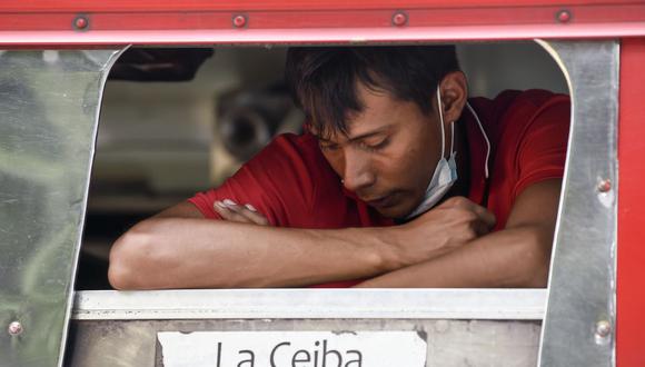 Un migrante hondureño espera dentro de un autobús afuera del refugio donde se hospedan en el municipio de San Marcos, Guatemala, el 3 de octubre de 2020. (Foto de ALFREDO ESTRELLA / AFP).