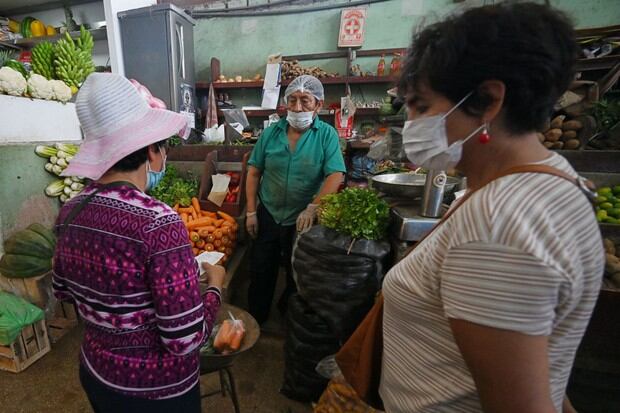 Los compradores usan mascarillas para evitar la propagación del nuevo coronavirus en un mercado de Lima (Foto: Cris Bouroncle / AFP)