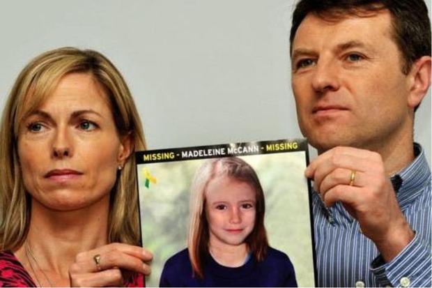 Madeleine McCann's parents hold up a photo of what their daughter would have looked like in 2012.