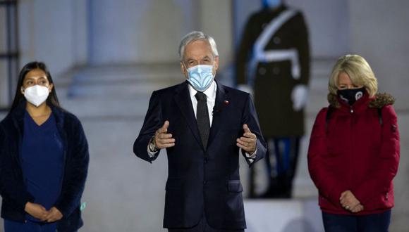 El presidente de Chile, Sebastián Piñera (Centro), durante un homenaje a las víctimas de la pandemia del coronavirus COVID-19 en el palacio presidencial de La Moneda, en Santiago. (Foto: CLAUDIO REYES / AFP).