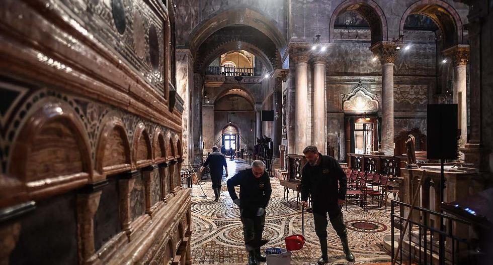 Personas trapean la basílica de San Marcos luego de la inundación que azotó Venecia. (Foto: MARCO BERTORELLO / AFP)