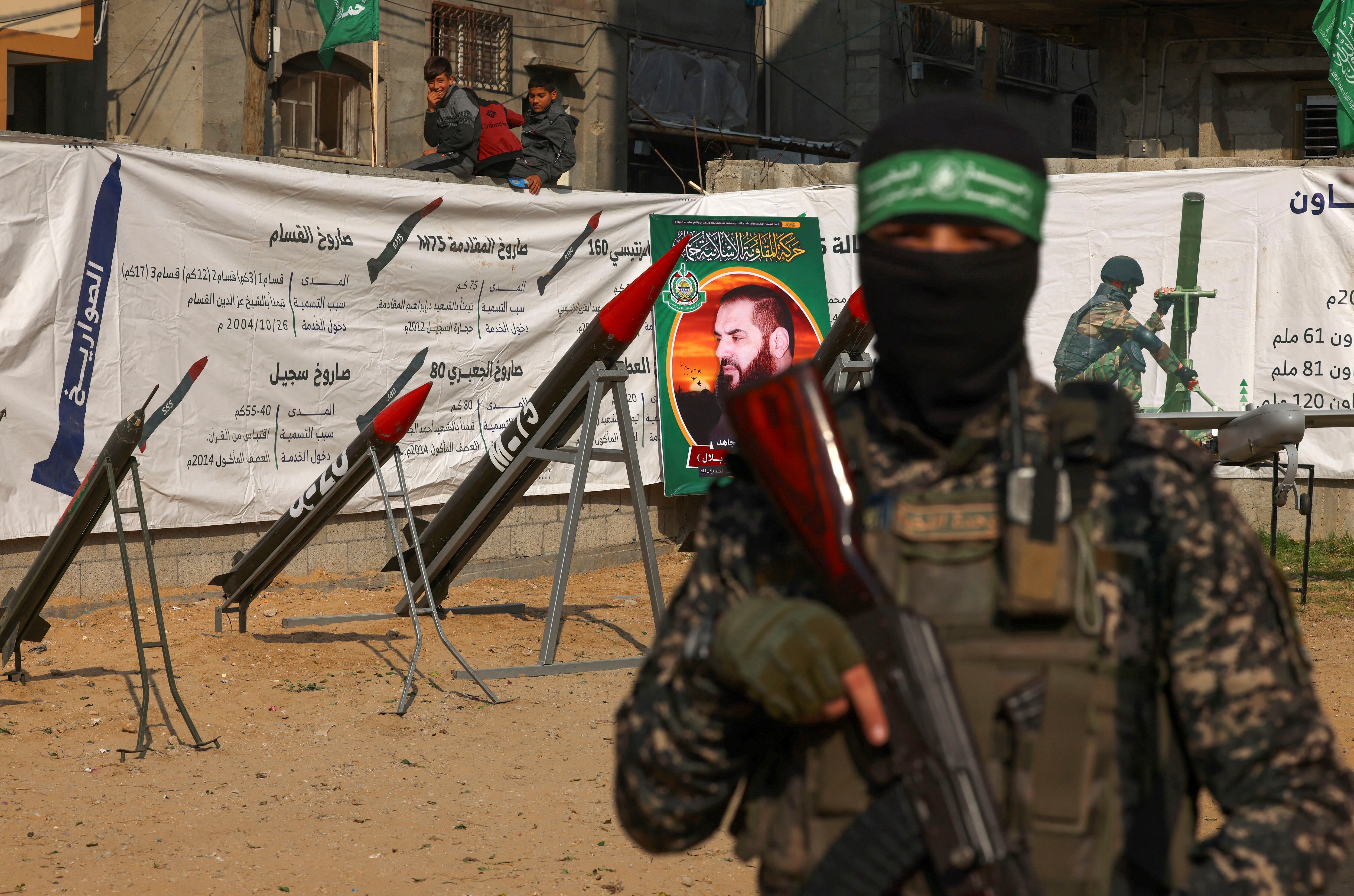 Children watch the Palestinian movement Hamas display rockets and a military drone during an exhibition in the Jabalia refugee camp, north of Gaza, on December 9, 2022. (Photo by MOHAMMED ABED/AFP).