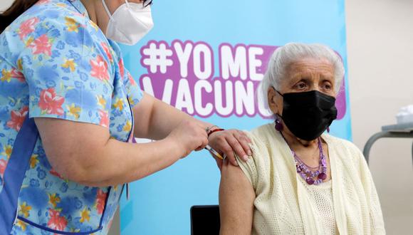 Una mujer recibe una dosis de la vacuna Pfizer-BioNTech contra el coronavirus COVID-19 en un centro de vacunación en Santiago, el 10 de enero de 2022. (Javier TORRES / AFP).