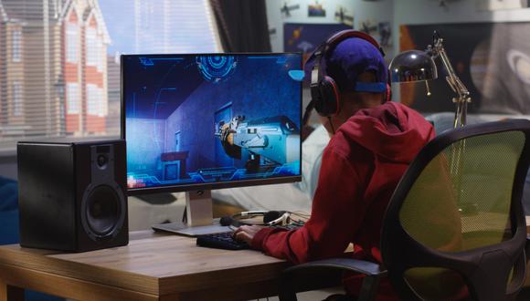 Medium shot of a boy playing with a first-person shooter video game