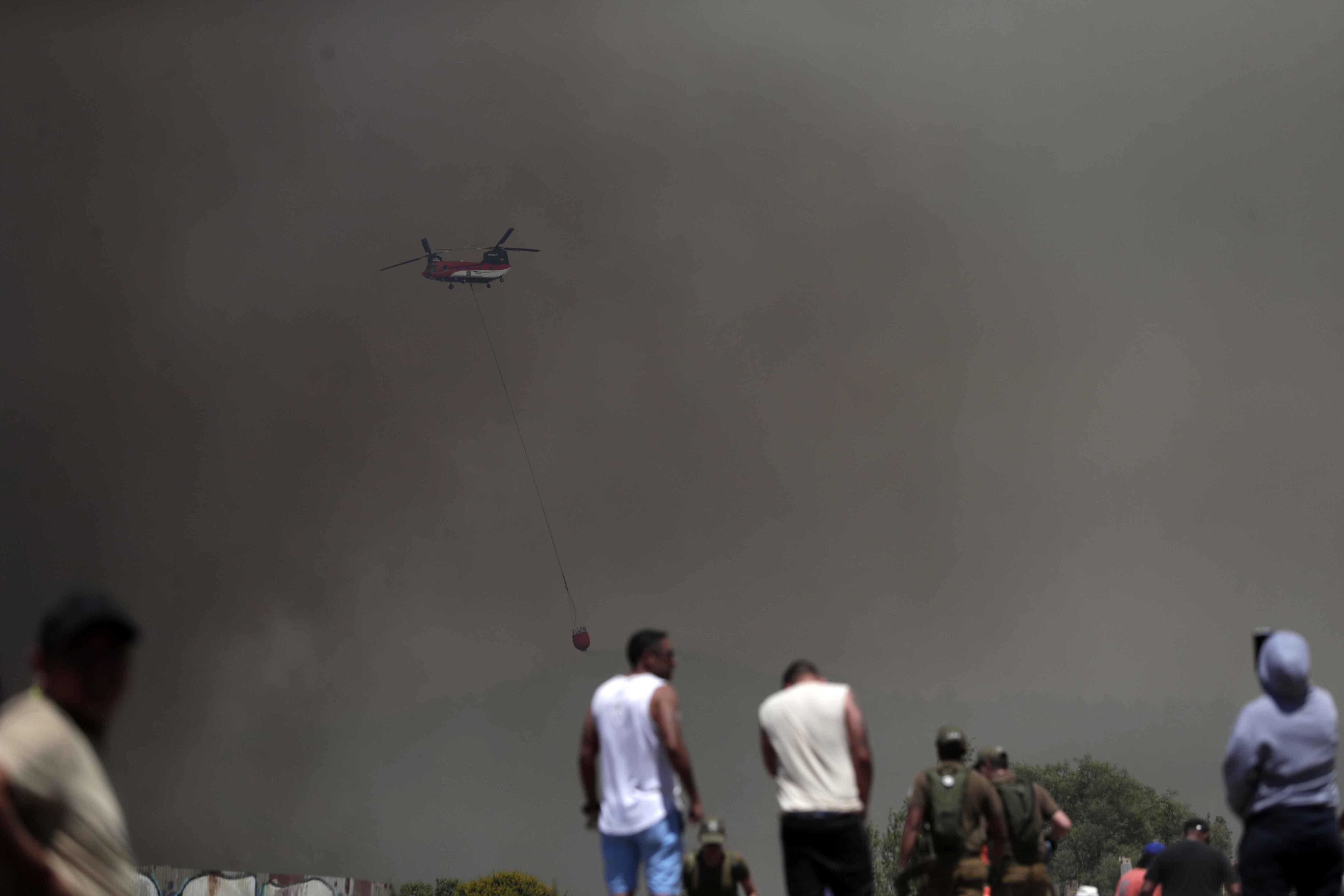Helicopters worked tirelessly on suppression efforts.  (EPA/EFE).