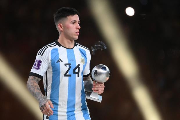Argentina's midfielder #24 Enzo Fernandez receives the Young Player award during the Qatar 2022 World Cup trophy ceremony after the football final match between Argentina and France at Lusail Stadium in Lusail, north of Doha on December 18, 2022. - Argentina won in the penalty shoot -out.  (Photo by FRANCK FIFE / AFP)