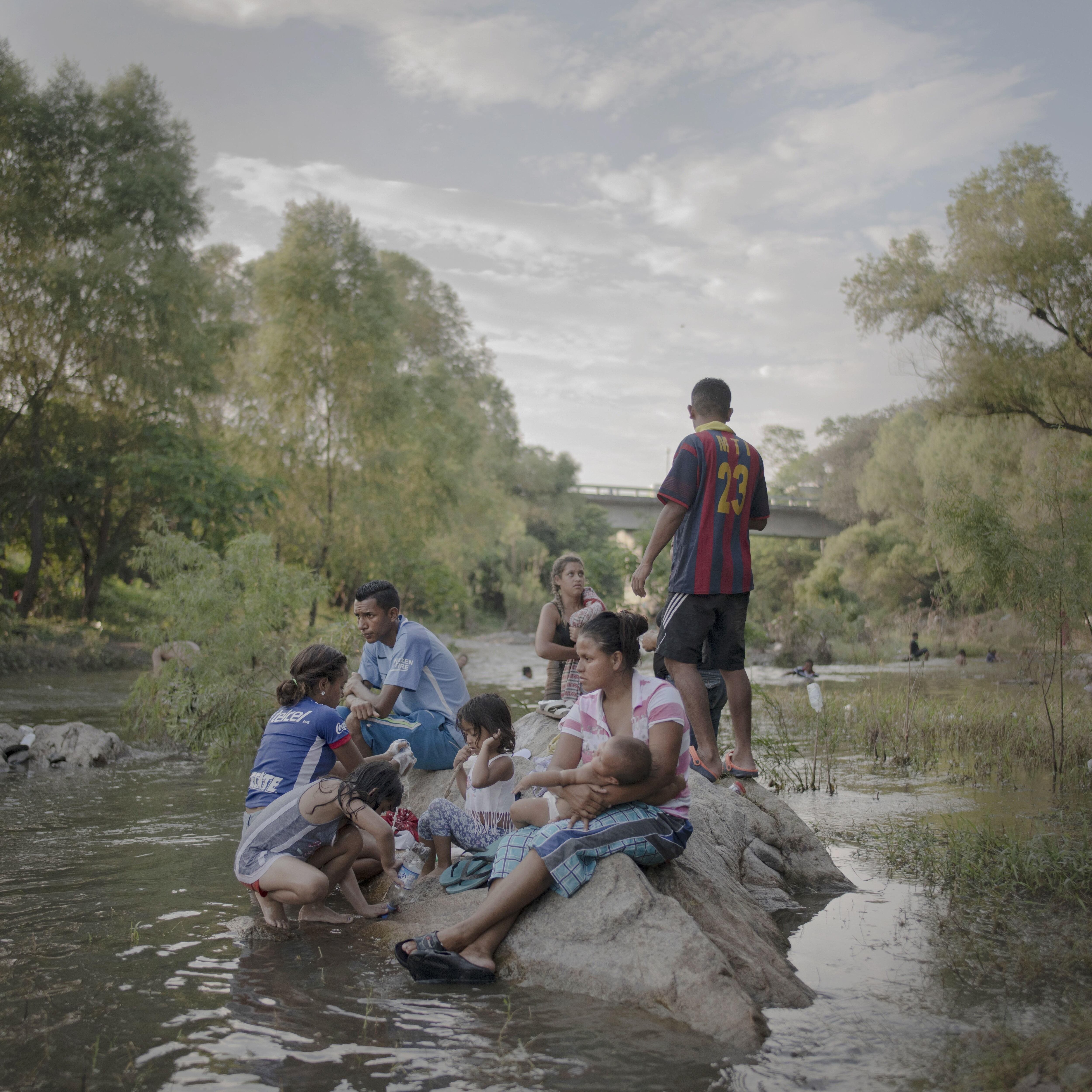 Image from 2019 that shows a family bathing during a day of rest for the migrant caravan heading to the north of the continent.  EFE