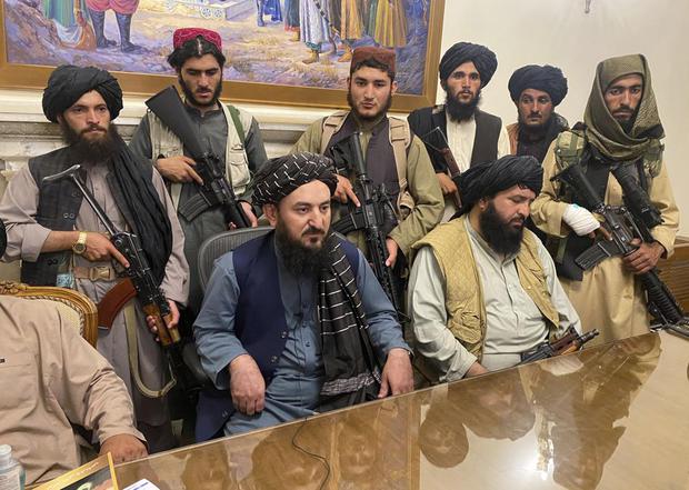 Taliban fighters take control of Afghanistan's presidential palace in Kabul after President Ashraf Ghani fled the country on Sunday, August 15, 2021.