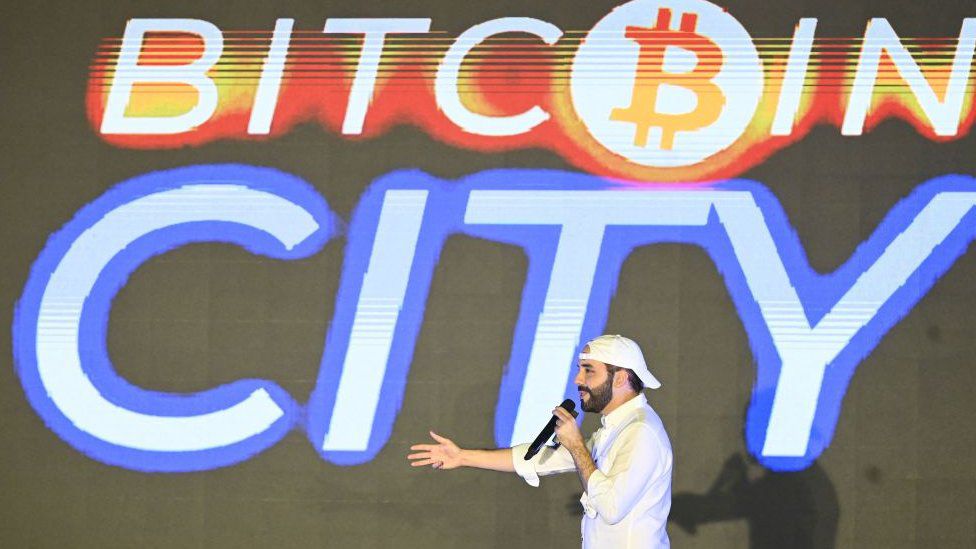 Bukele with a screen that says Bitcoin City.  (GETTY IMAGES).