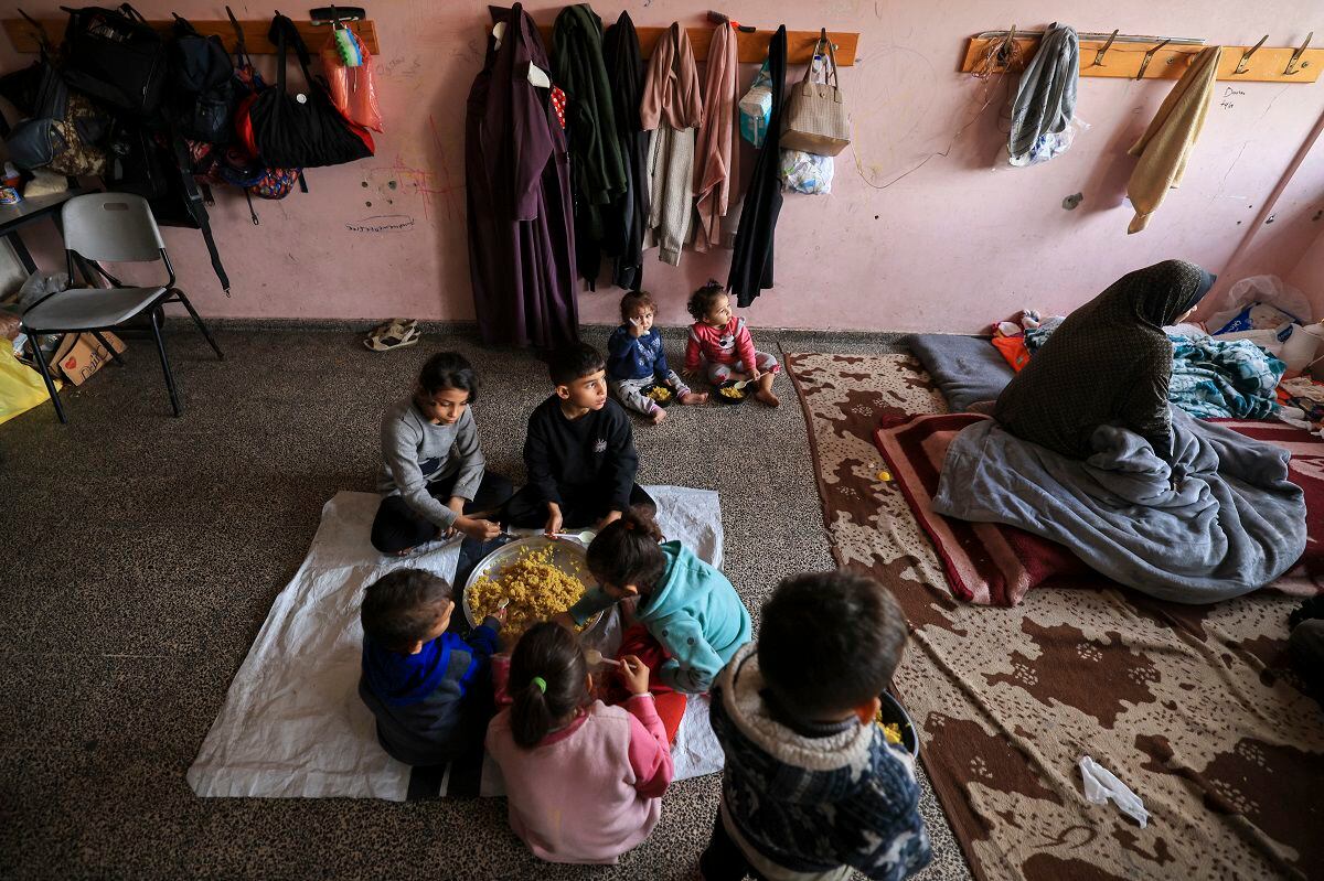 Displaced Palestinians take refuge in a school in Deir al-Balah, central Gaza Strip, on December 27, 2023. (Photo by Mahmud HAMS/AFP)