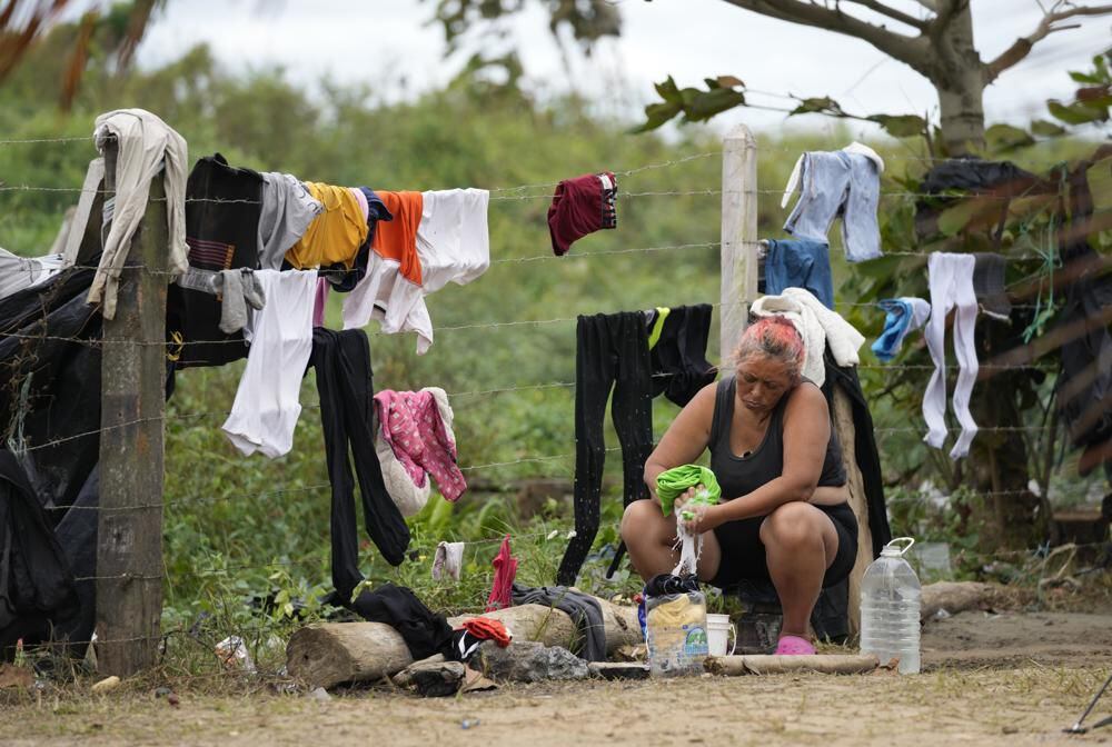 Migrants, mostly Venezuelans, cross the Darién Gap from Colombia to Panama in hopes of reaching the United States, Saturday, Oct. 15, 2022. (AP Photo/Fernando Vergara)