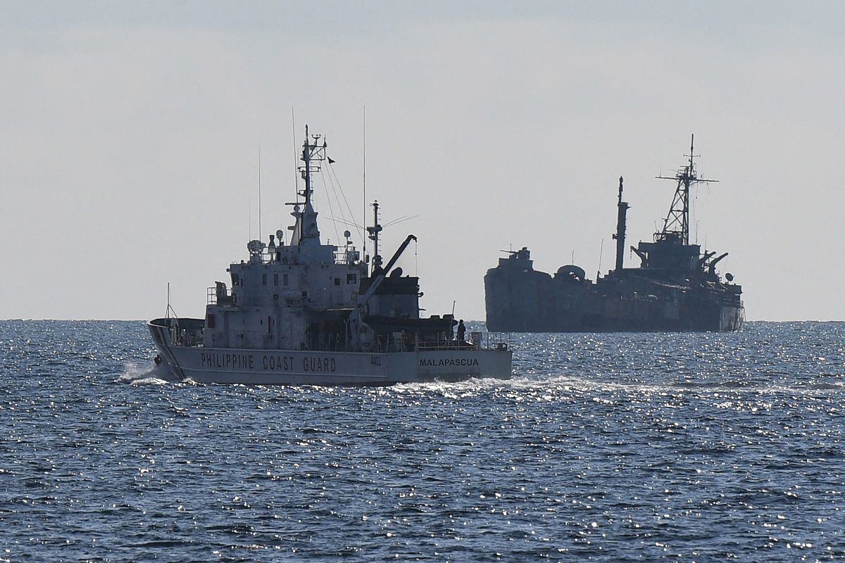 The Philippine coast guard ship BRP Malapascua patrols near the stranded Navy ship BRP Sierra Madre in the Spratly Islands in the disputed South China Sea.  (Photo by Ted ALJIBE/AFP)