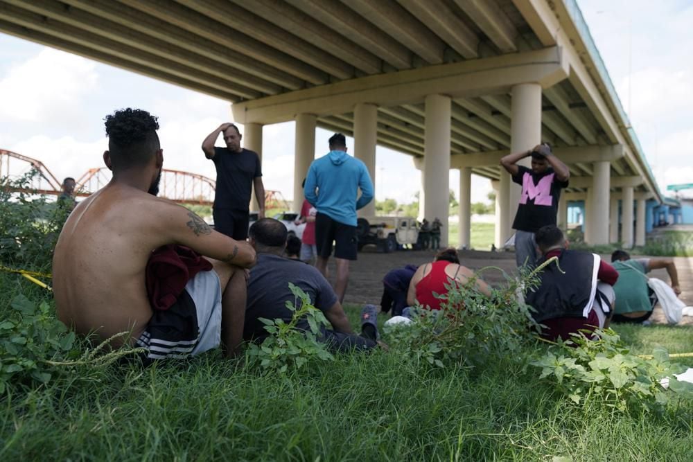 Migrants await processing by Border Patrol after illegally crossing the Rio Grande from Mexico into the United States in Eagle Pass, Texas, on Friday, Aug. 26, 2022. (AP Photo/Eric Gay, File)