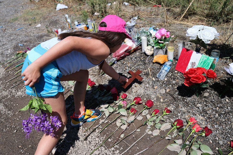 Girl leaves flowers at the place where the truck was found.  (GETTY IMAGES)