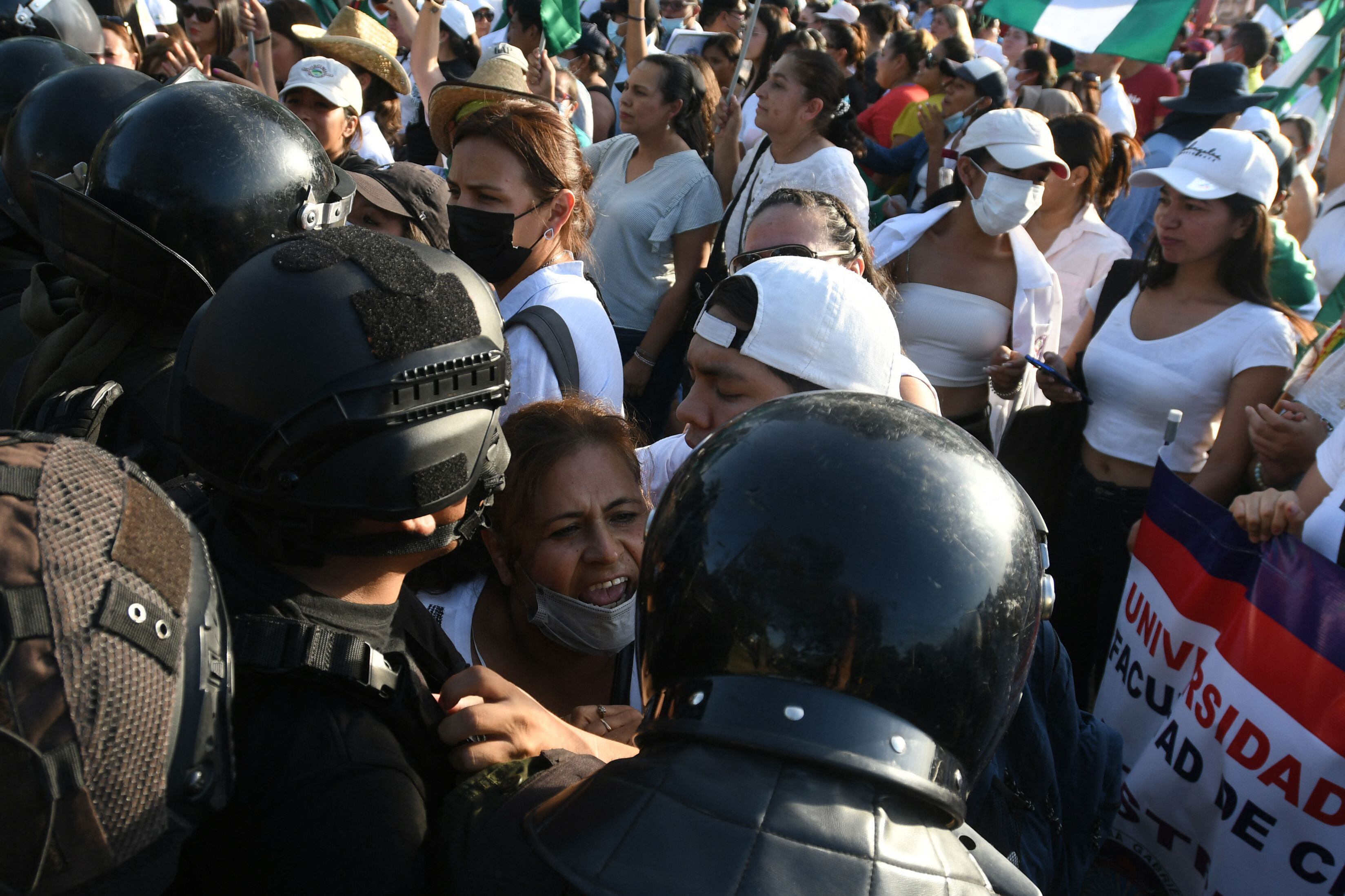 A woman struggles with police during a demonstration called by the Gabriel René Moreno Autonomous University (UAGRM) demanding the release of Santa Cruz Governor Luis Fernando Camacho in Santa Cruz, Bolivia.