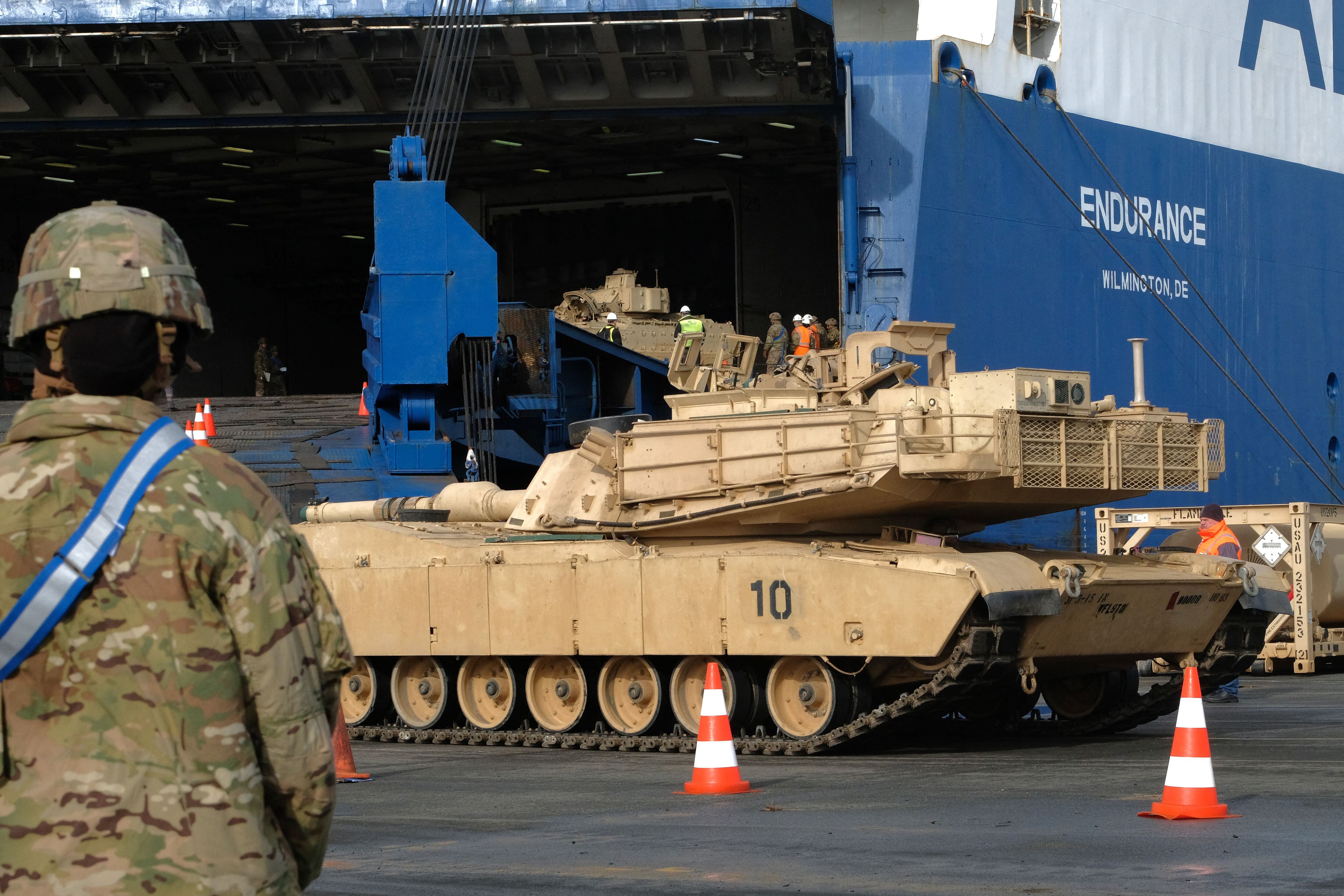 Military personnel unload an M1 Abrams battle tank at the port of Bremerhaven, United States, on February 21, 2020. (Photo by Patrik Stollarz/AFP).