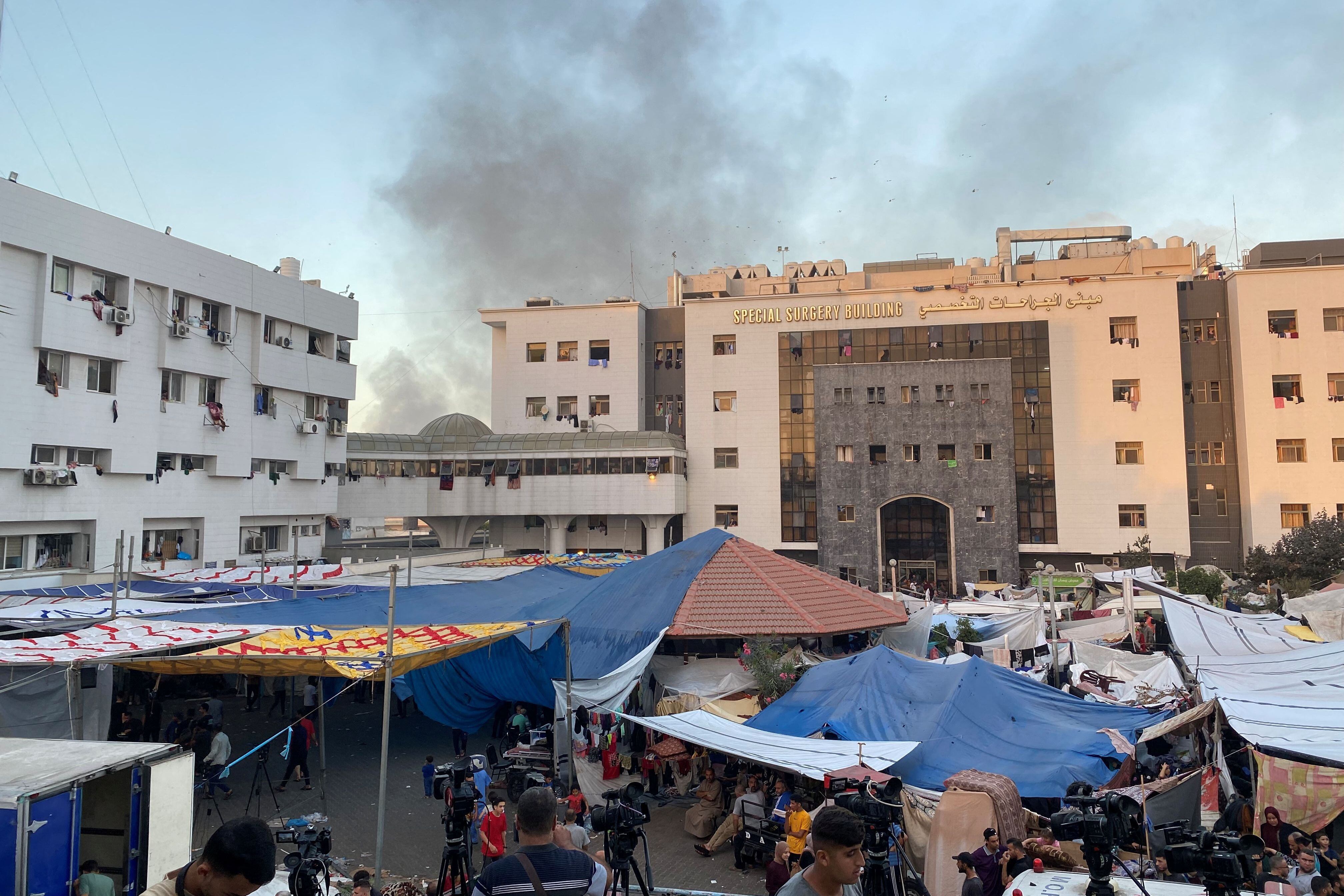 Smoke rises as displaced Palestinians take refuge in Al Shifa hospital, November 8, 2023. (REUTERS/Doaa Rouqa).