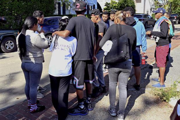 A group of immigrants gather outside St. Andrew's Episcopal Church in Martha's Vineyard, Massachusetts.  Florida Governor Ron DeSantis sent two planes with migrants to Martha's Vineyard.  (AP via Ron Schlorb/The Cape Cod Times)