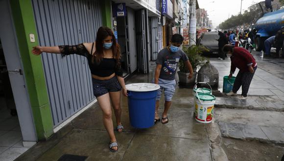 Vecinos de SJL juntan agua tras el aniego que afecta el distrito. (Foto: Eduardo Cavero/ @photo.gec9