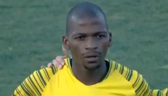 La reacción de uno de los futbolistas de Sudáfrica al escuchar las interrupciones del himno nacional. (Foto: captura de video)
