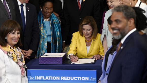 La presidenta de la Cámara de Representantes de los Estados Unidos, Nancy Pelosi, firma la Ley de Reducción de la Inflación después de que la Cámara de Representantes votara 220-207 para aprobarla en el Capitolio de los Estados Unidos en Washington, DC. (Foto de OLIVIER DOULIERY / AFP)