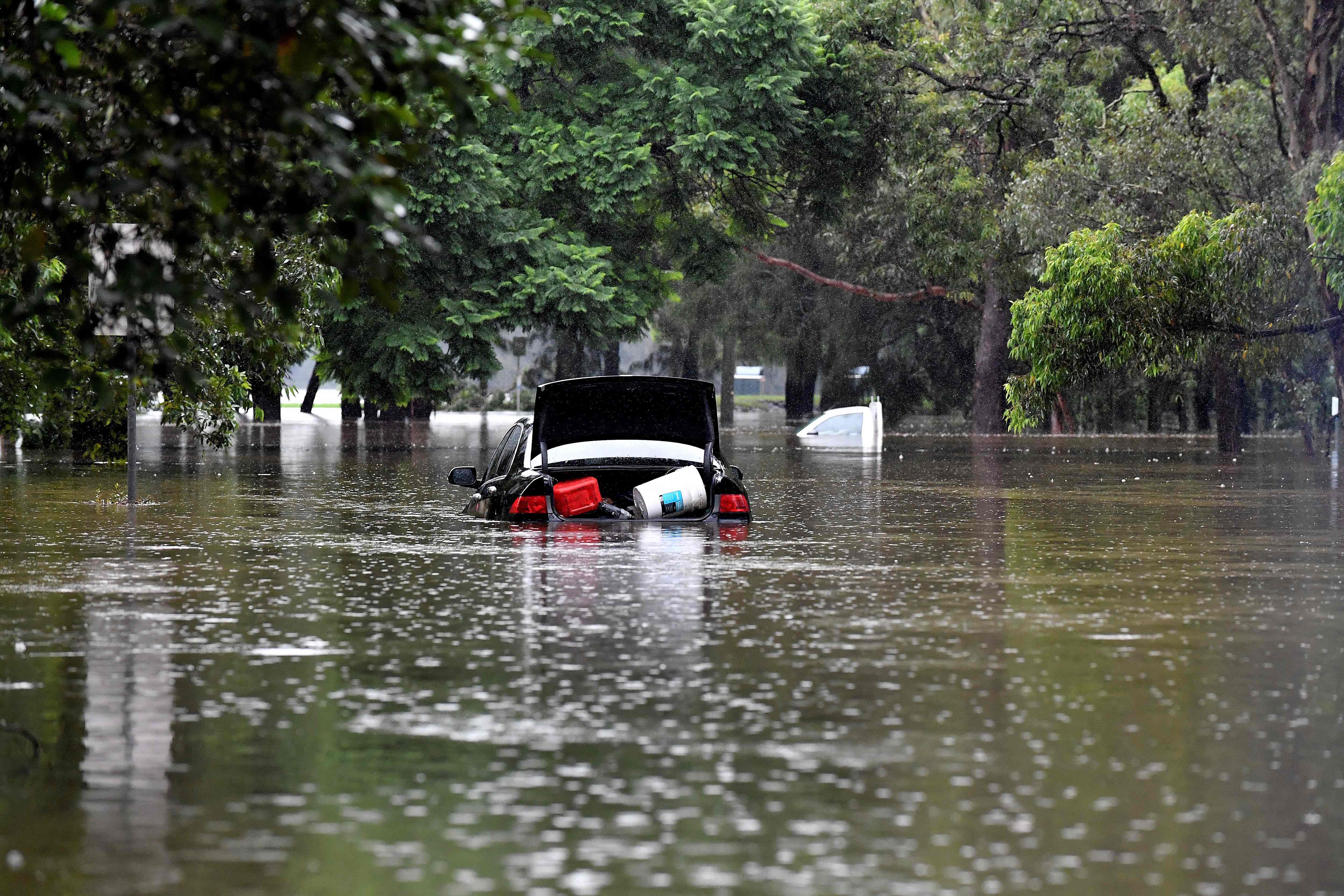 Cars were stranded in floodwaters in the southwestern suburb of Sydney.  (Photo: Muhammad FAROOQ / AFP)
