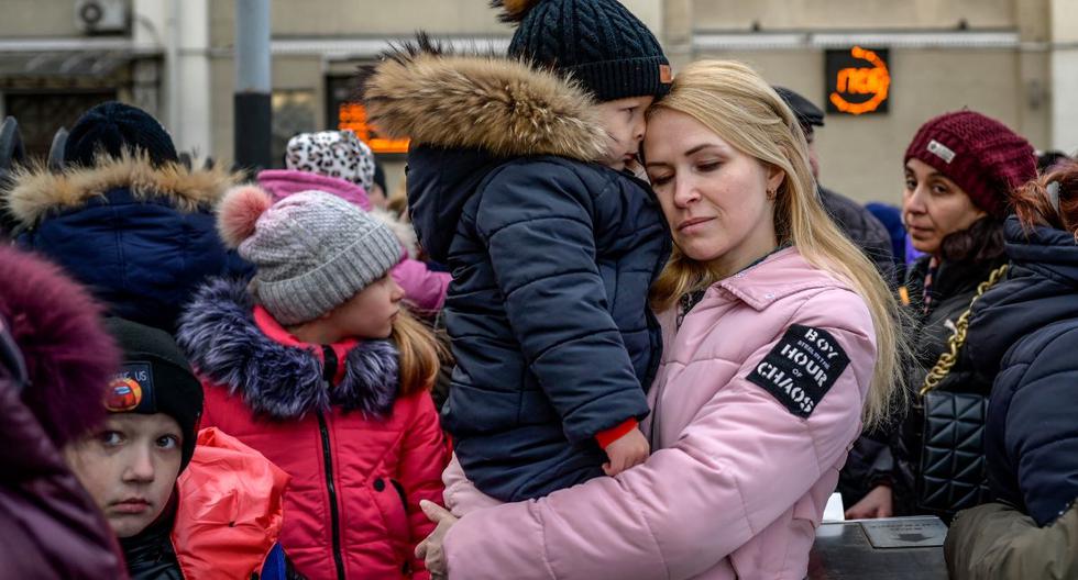 Una mujer abraza a un niño mientras esperan en una plataforma para evacuar la ciudad de Odessa, en Ucrania. (BULENT KILIC / AFP).