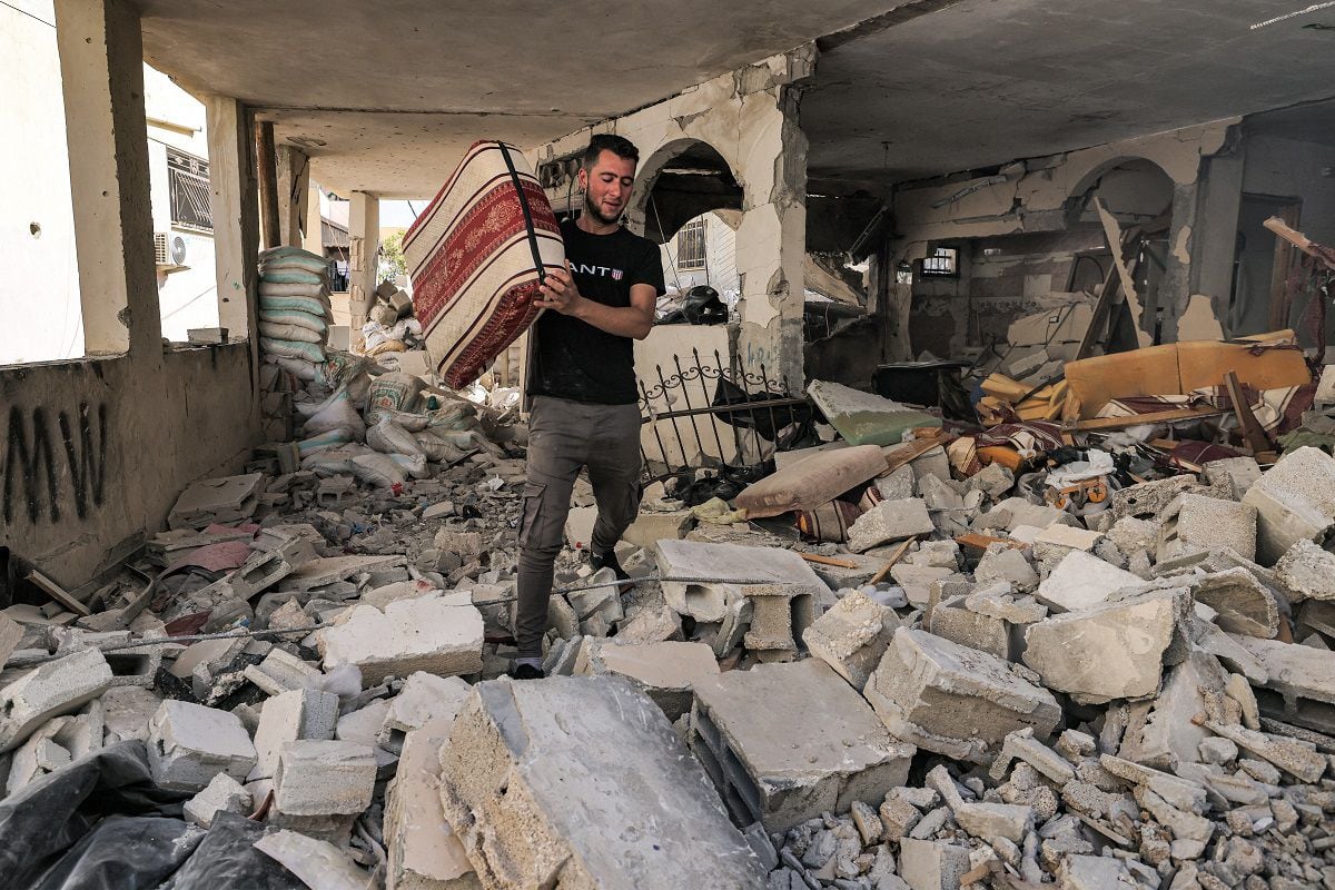 A man walks through the rubble of a destroyed apartment in Jenin, in the occupied West Bank, on July 5, 2023, after the Israeli army declared the end of a two-day military operation in the area.  (Photo by AHMAD GHARABLI / AFP)