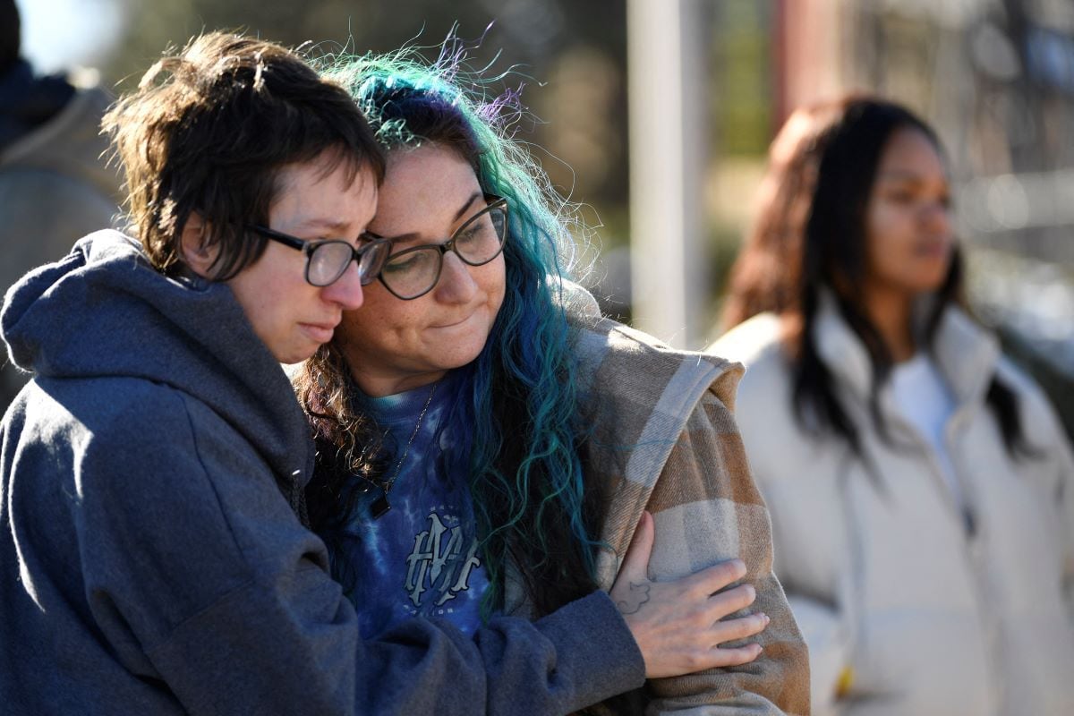 Jessy Smith Cruz hugs Jadzia Dax McClendon the morning after a mass shooting at Club Q in Colorado.  (Jason Connolly/AFP)
