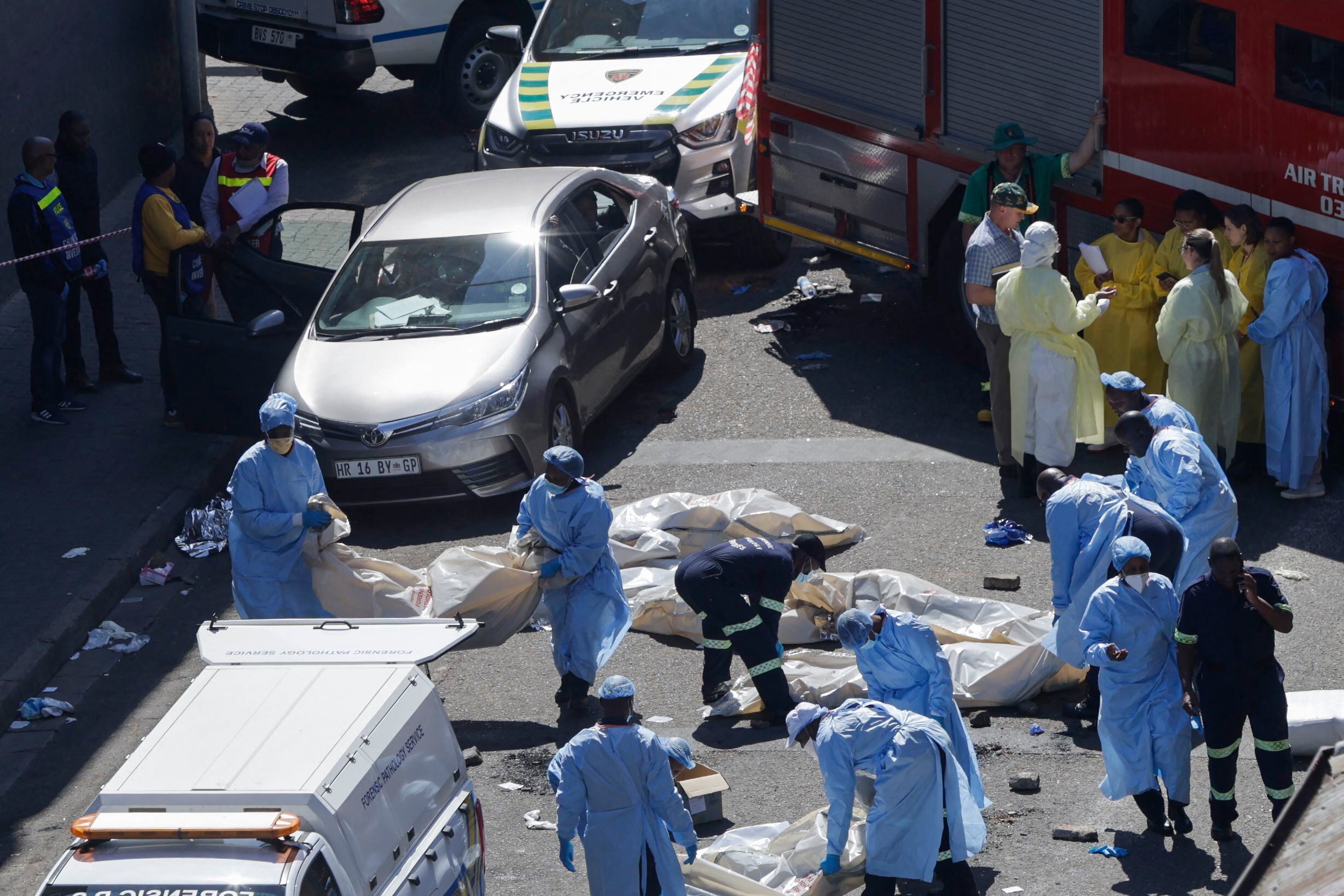 EDITOR'S NOTE: Graphic Content / Members of the forensic department move bodies at the scene of a fire in Johannesburg on August 31, 2023. More than 70 people died in a fire that tore through a five-story building in downtown Johannesburg on August 31. August 2023. 2023, the South African city's emergency services said.  (Photo: Guillem SARTORIO / AFP)