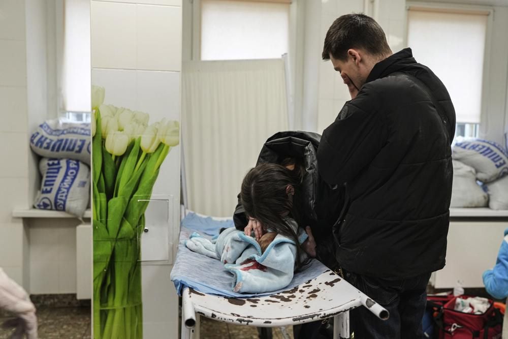 Marina Yatsko, left, and her boyfriend Fedor mourn the lifeless body of their 18-month-old son Kirill, killed in a shelling, as he lay on a stretcher at a hospital in Mariupol, Ukraine.  (Photo: AP/Evgeni Maloletka)