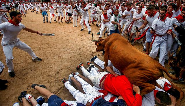 A wild cow leaps over revelers in the bull ring following the fourth running of the bulls at the San Fermin festival in Pamplona, Spain July 10, 2017. REUTERS/Joseba Etxaburu     TPX IMAGES OF THE DAY