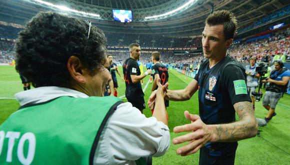 Mario Mandzukic extendió su mano al fotógrafo Yuri Cortez luego de que el equipo de Croacia cayera sobre él al celebrar un gol ante Inglaterra. (Foto: EFE/Peter Powell)