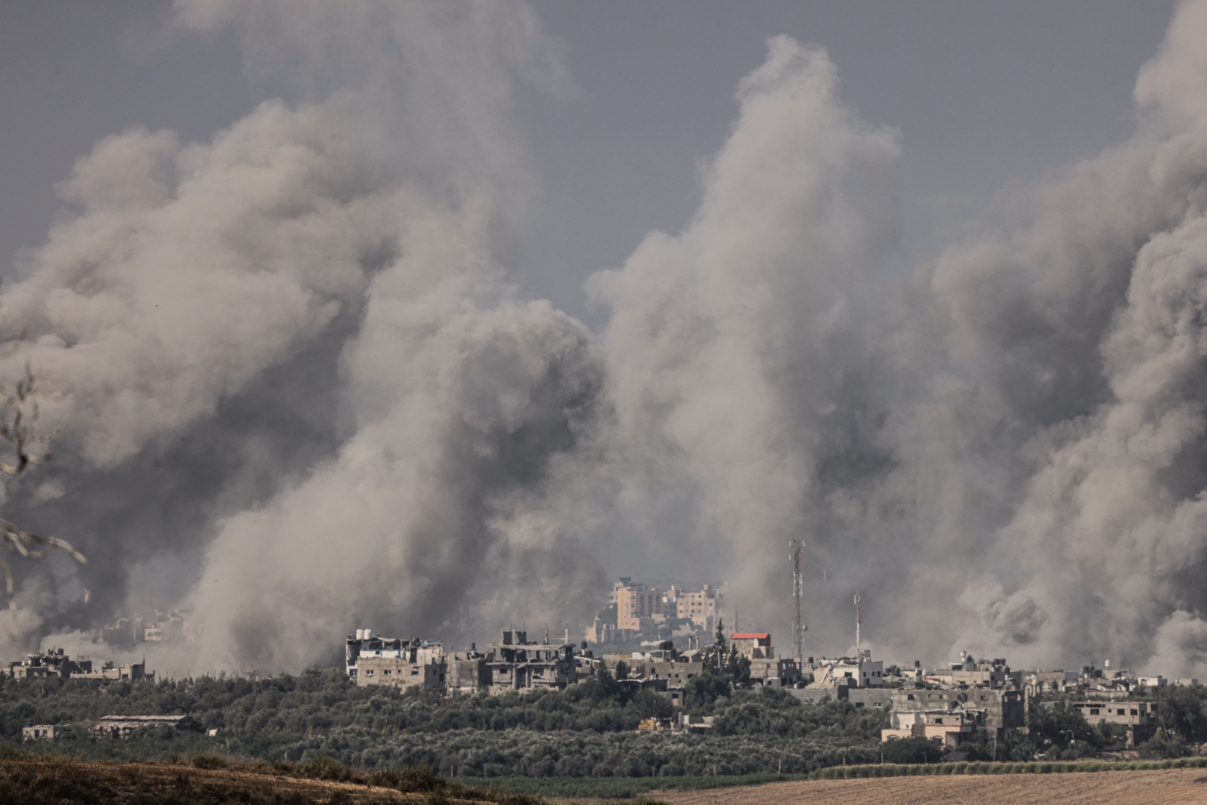 A photograph taken from the city of Sderot in southern Israel on October 23, 2023, shows smoke rising over the northern Gaza Strip following an Israeli attack.  (Photo by Jack Guéz/AFP).