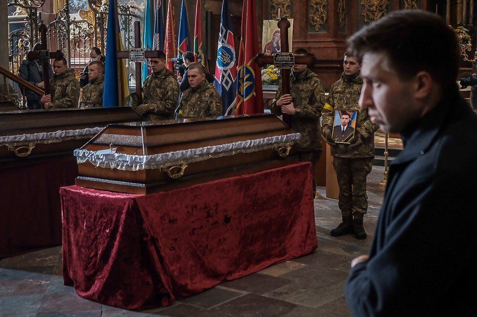 Saints Peter and Paul Church now holds funerals almost every day.  Local soldiers carry out ceremonial duties.