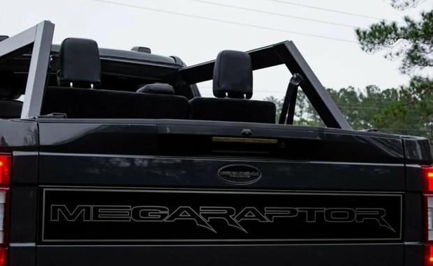 It features a laser-etched, gloss black custom rear door panel emblazoned with MegaRexx ® badging "MegaRexx® Trucks" Matching rear end wraps