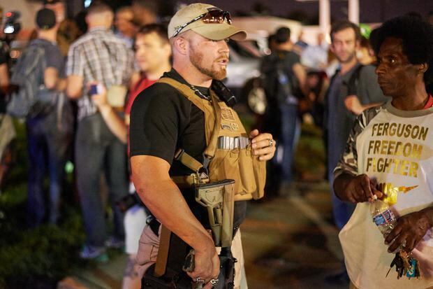 A member of the Oath Keepers walks with his personal weapon down the street during protests in Ferguson, Missouri, on August 10, 2015. The Oath Keepers organization says its members, all former military personnel, police officers and first responders, are they commit to "defend the Constitution against all enemies, foreigners and nationals."  (Photo: AFP)