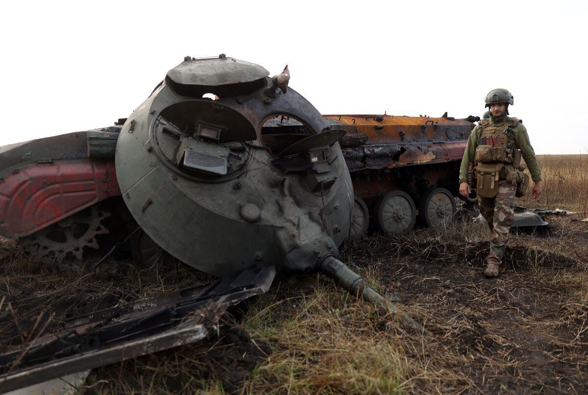 A Ukrainian soldier walks past a destroyed Russian tank on the front line with Russian troops in the Donetsk region on September 28, 2022. (Anatolii Stepanov / AFP)