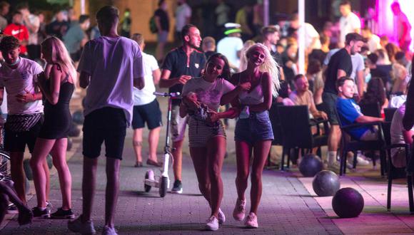 Varios turistas pasean por una zona de discotecas y pubs de Magaluf, en Mallorca, España, país que registra un fuerte rebrote de coronavirus. (JOAN MATEU / AP).