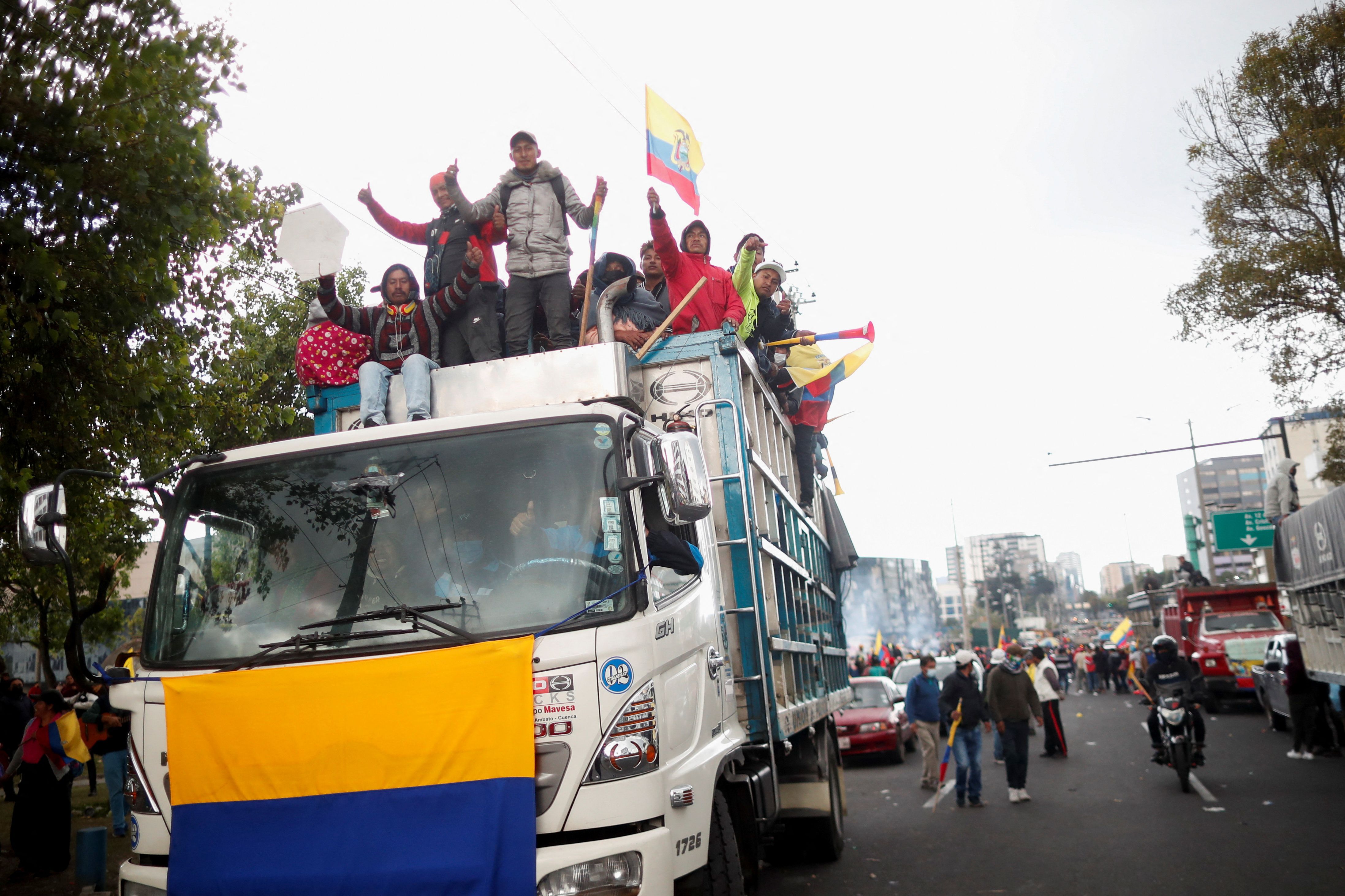 People celebrate after the signing of an agreement between indigenous organizations and the Ecuadorian government, in Quito, Ecuador.
