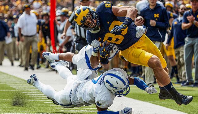 Sep 16, 2017; Ann Arbor, MI, USA; Michigan Wolverines tight end Zach Gentry (83) is knocked out by Air Force Falcons linebacker Ja'Mel Sanders (7) in the first half at Michigan Stadium. Mandatory Credit: Rick Osentoski-USA TODAY Sports     TPX IMAGES OF THE DAY