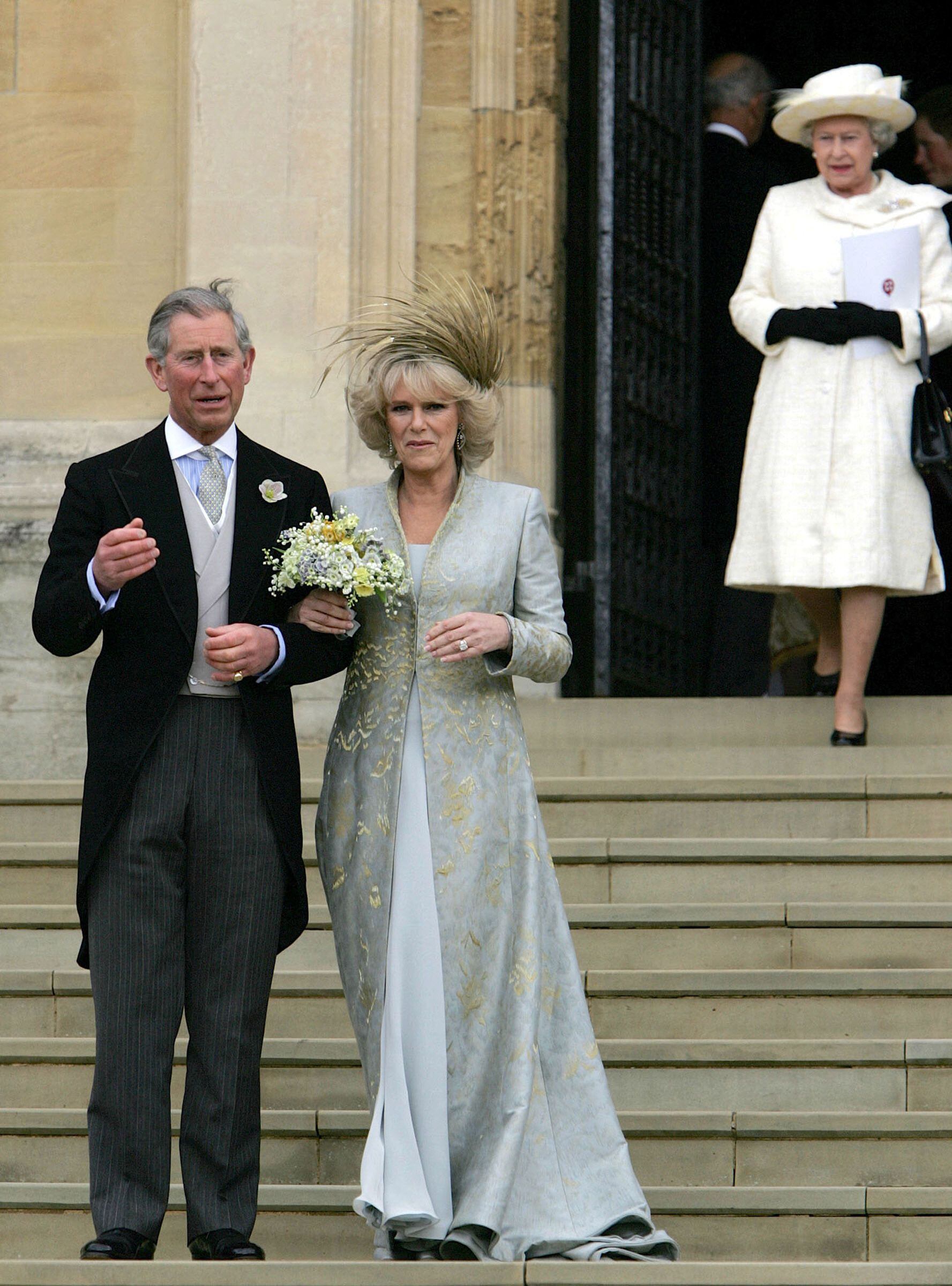 Stock Image |  Britain's Prince Charles and his bride Camilla, Duchess of Cornwall leave St George's Chapel in Windsor after the church blessing of their civil wedding ceremony, April 09, 2005. In the background is the Queen Elizabeth of Great Britain.  (Photo by ALASTAIR GRANT / POOL / AFP)