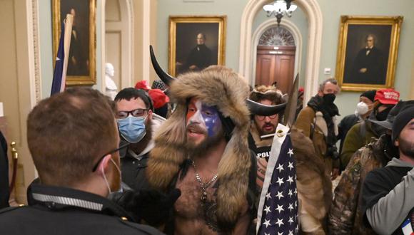 Jake Angeli, el hombre que asaltó el Capitolio vestido de bisonte, pide el perdón de Trump. (Foto: Saul LOEB / AFP).
